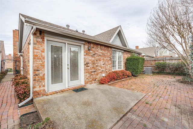 rear view of house with fence, a patio area, and brick siding