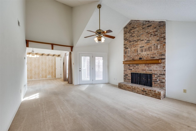 unfurnished living room with high vaulted ceiling, a fireplace, a ceiling fan, and carpet