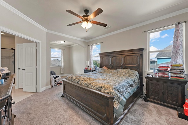 bedroom featuring visible vents, light carpet, ornamental molding, arched walkways, and baseboards