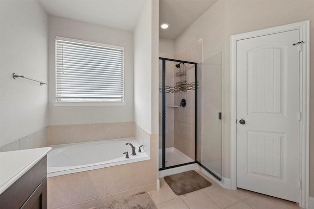 full bath featuring a bath, a shower stall, and tile patterned floors