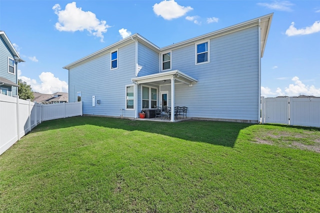 back of property featuring a lawn, a patio, a fenced backyard, and a gate