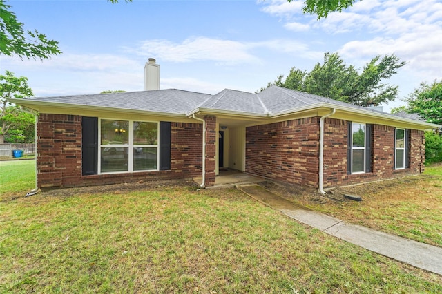 single story home featuring a front lawn, brick siding, a chimney, and a shingled roof