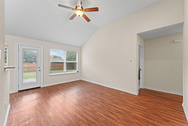 empty room featuring ceiling fan, baseboards, lofted ceiling, and wood finished floors