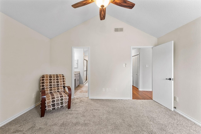 unfurnished room with visible vents, a ceiling fan, lofted ceiling, and carpet