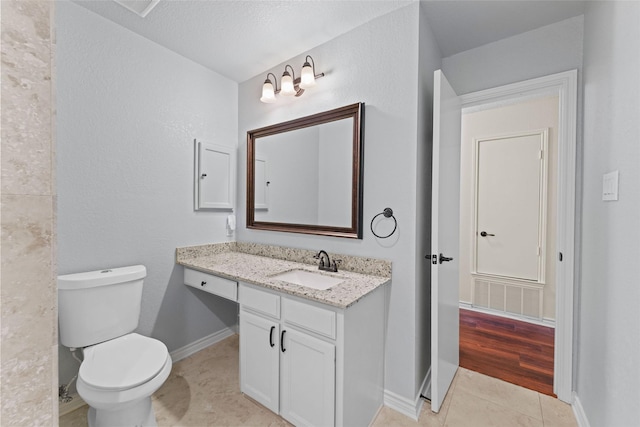 bathroom featuring tile patterned flooring, visible vents, baseboards, toilet, and vanity