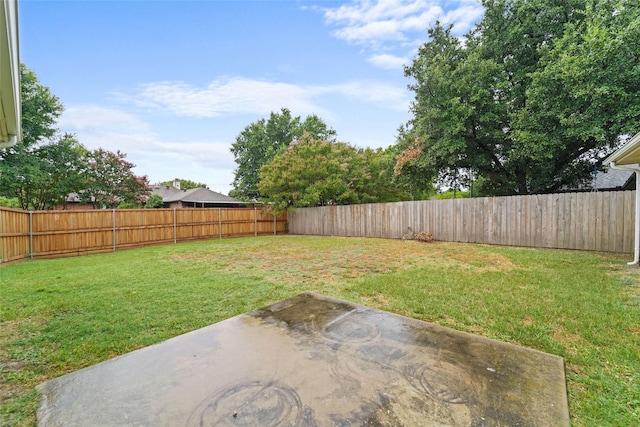 view of yard featuring a patio area and a fenced backyard