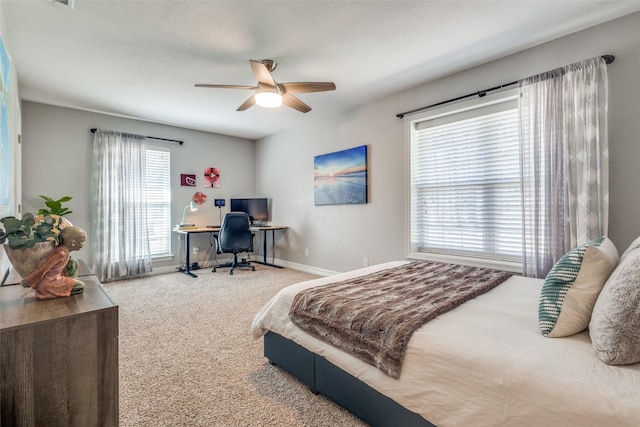 carpeted bedroom featuring a ceiling fan and baseboards