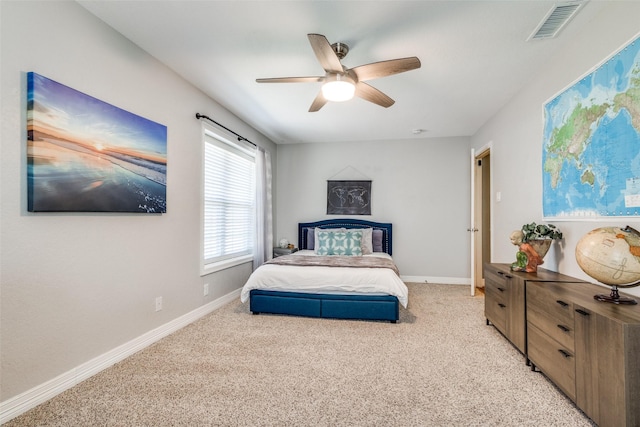 bedroom with ceiling fan, baseboards, visible vents, and light carpet