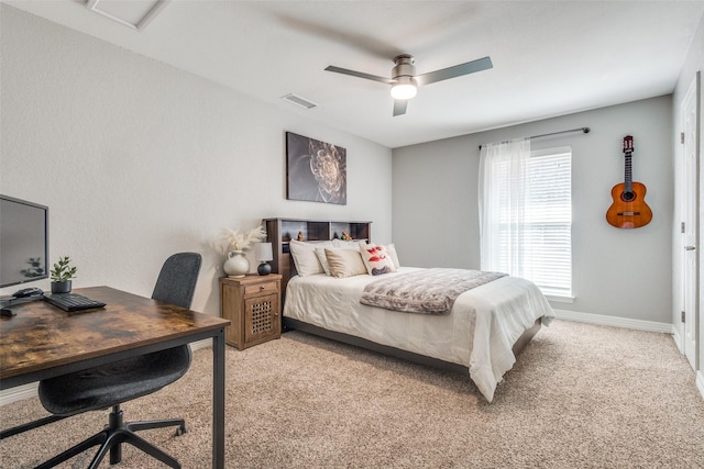 bedroom with visible vents, light colored carpet, a ceiling fan, and baseboards