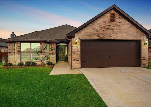 single story home with brick siding, an attached garage, concrete driveway, and a front lawn