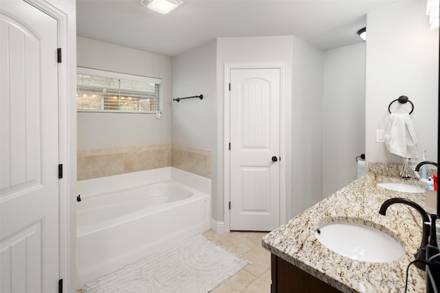 full bathroom with tile patterned flooring, double vanity, a garden tub, and a sink