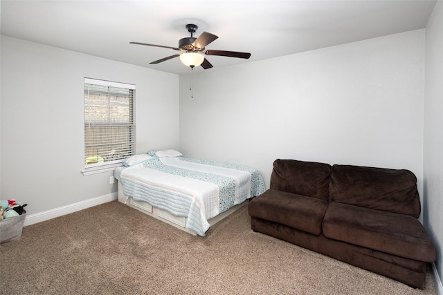 carpeted bedroom featuring baseboards and a ceiling fan