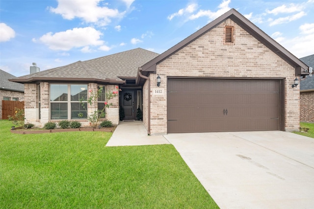 view of front facade featuring a front yard, an attached garage, a shingled roof, concrete driveway, and brick siding