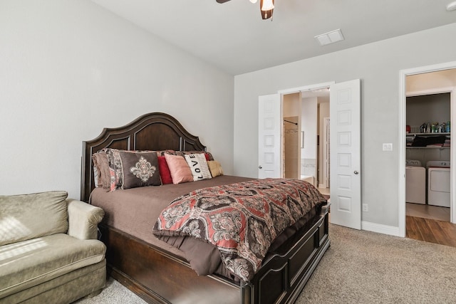 carpeted bedroom with visible vents, baseboards, separate washer and dryer, and ceiling fan