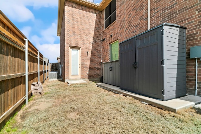 back of property with fence and brick siding