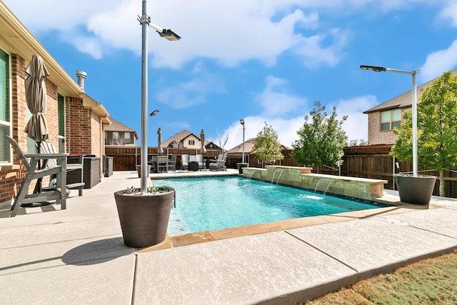 view of swimming pool featuring a patio area, a fenced in pool, and a fenced backyard