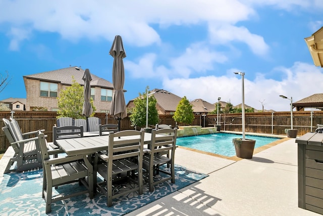 view of pool with a patio, outdoor dining area, a fenced in pool, and a fenced backyard