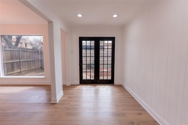 doorway with recessed lighting, french doors, baseboards, and wood finished floors