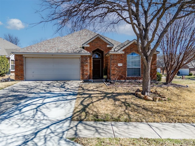 ranch-style house featuring a garage, brick siding, roof with shingles, and concrete driveway