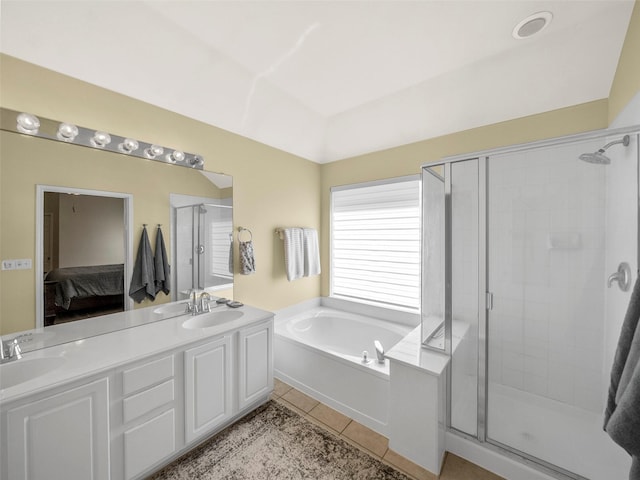 ensuite bathroom featuring tile patterned flooring, a shower stall, a sink, and connected bathroom