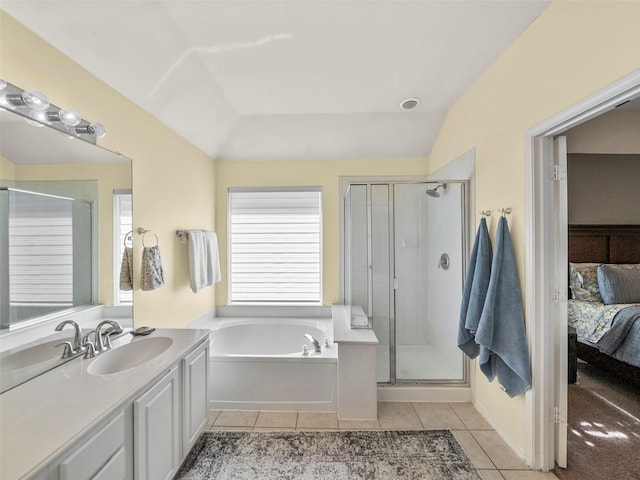 bathroom with connected bathroom, a shower stall, a garden tub, vaulted ceiling, and tile patterned floors