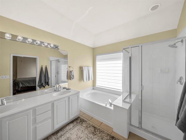 ensuite bathroom featuring a stall shower, tile patterned flooring, a bath, and double vanity
