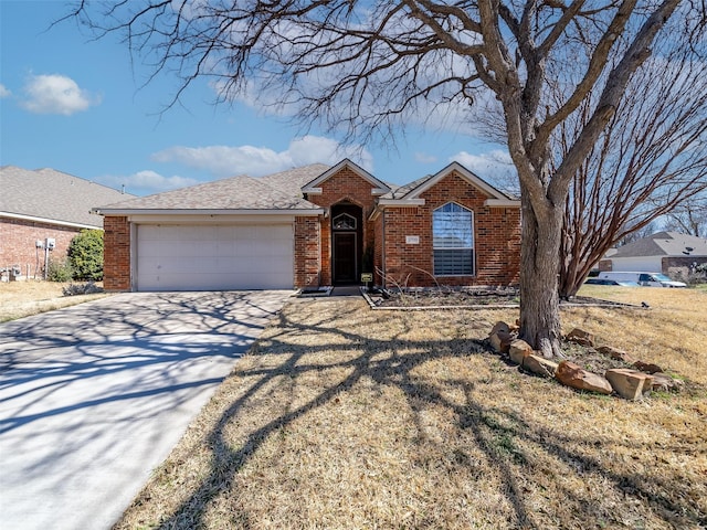 single story home featuring brick siding, an attached garage, concrete driveway, and roof with shingles