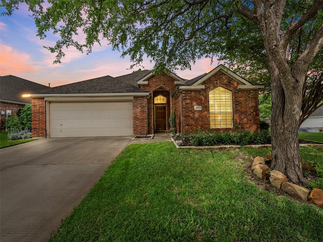 ranch-style house with a garage, brick siding, concrete driveway, a front lawn, and roof with shingles