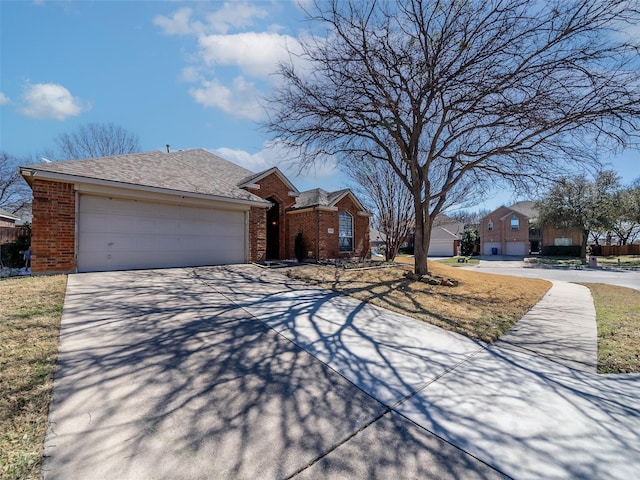 view of front of property with brick siding, driveway, a garage, and roof with shingles