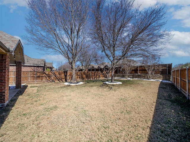 view of yard with a fenced backyard