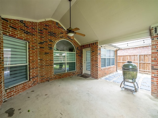 view of patio with ceiling fan and fence