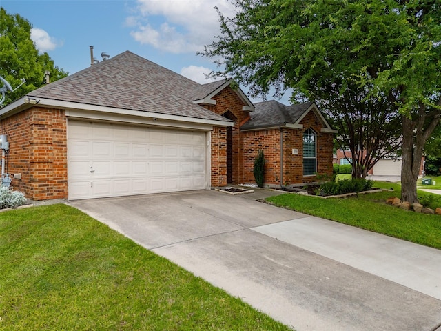 view of front facade with brick siding, driveway, a shingled roof, and a front yard