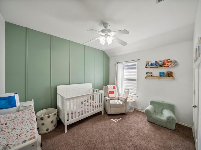 carpeted bedroom with visible vents, ceiling fan, and a nursery area