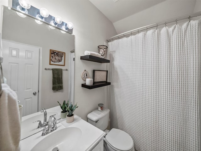full bath with lofted ceiling, toilet, and vanity