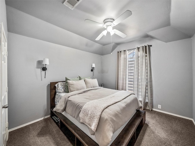 bedroom featuring visible vents, baseboards, dark colored carpet, lofted ceiling, and ceiling fan