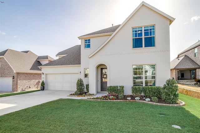 traditional-style house featuring stucco siding, an attached garage, concrete driveway, and a front yard