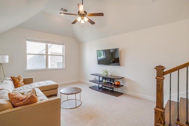 carpeted living room with baseboards, lofted ceiling, a ceiling fan, and stairs