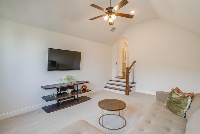 living area featuring a ceiling fan, visible vents, stairs, vaulted ceiling, and carpet flooring