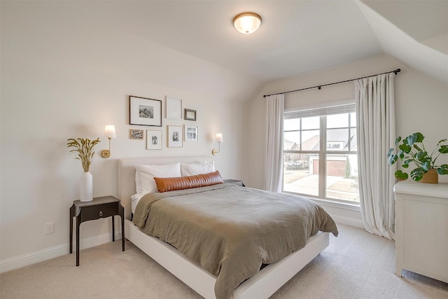 bedroom featuring light carpet, baseboards, and lofted ceiling