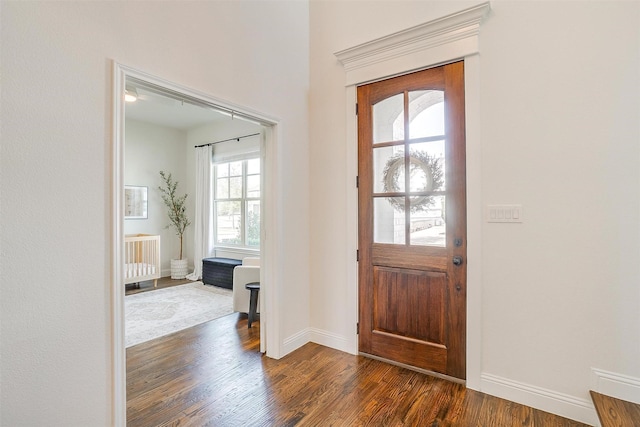 entrance foyer with baseboards and dark wood-style flooring