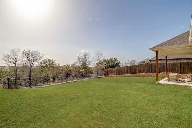 view of yard with a patio and a fenced backyard