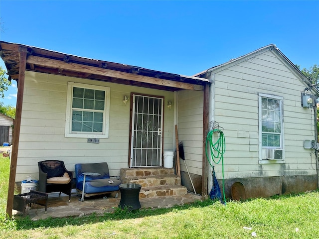 back of property featuring entry steps and cooling unit