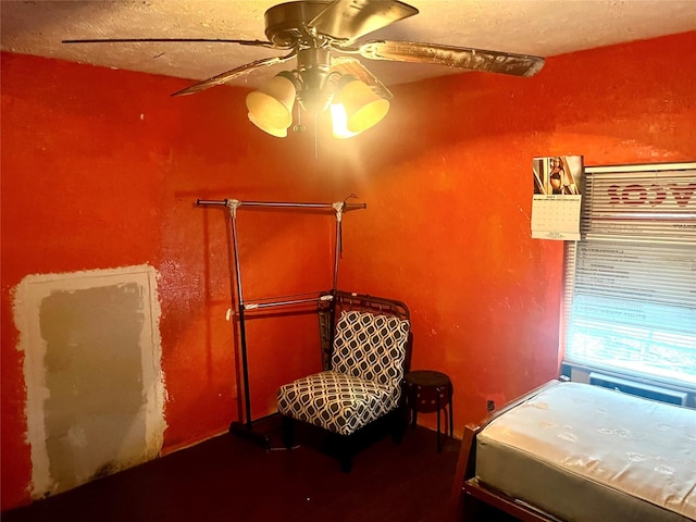 bedroom with a textured ceiling and a ceiling fan