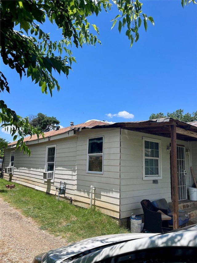 view of side of home featuring cooling unit