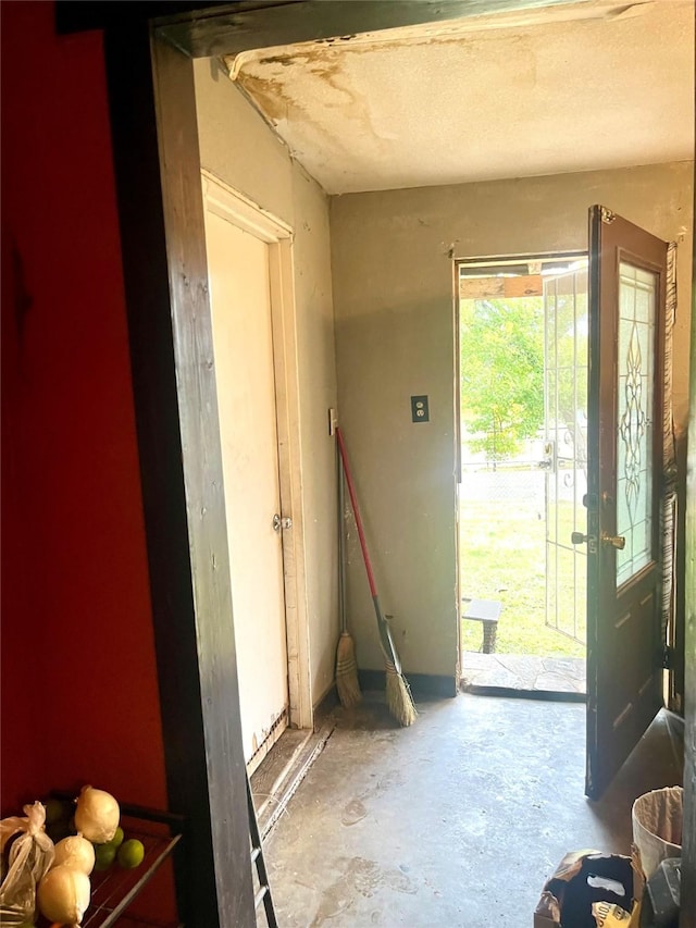 doorway featuring unfinished concrete floors