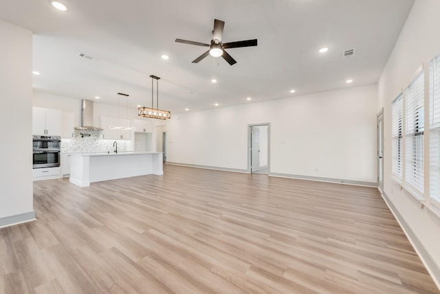 unfurnished living room featuring light wood finished floors, visible vents, recessed lighting, and ceiling fan