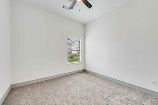 carpeted empty room featuring a ceiling fan, baseboards, and visible vents