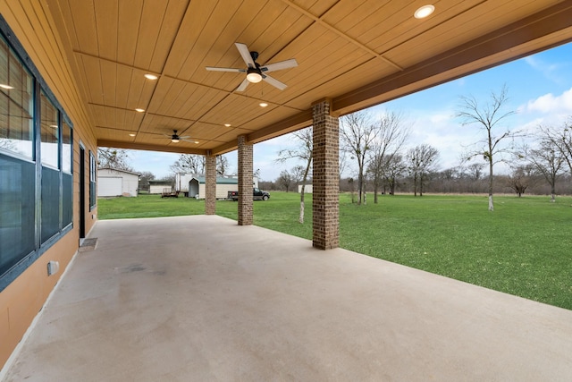 view of patio featuring an outdoor structure and ceiling fan