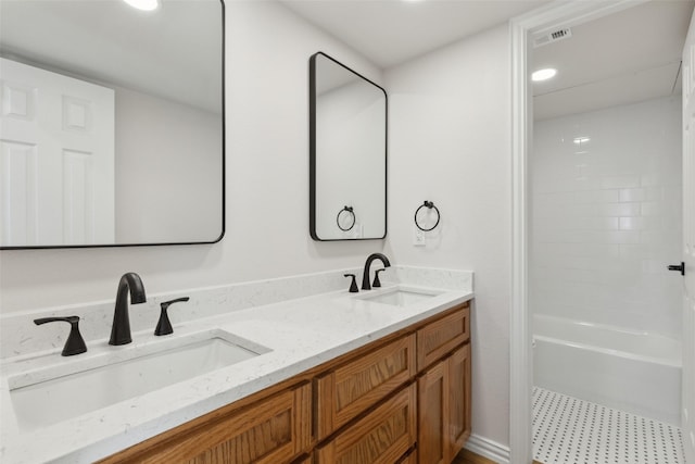 bathroom featuring double vanity, recessed lighting, visible vents, and a sink