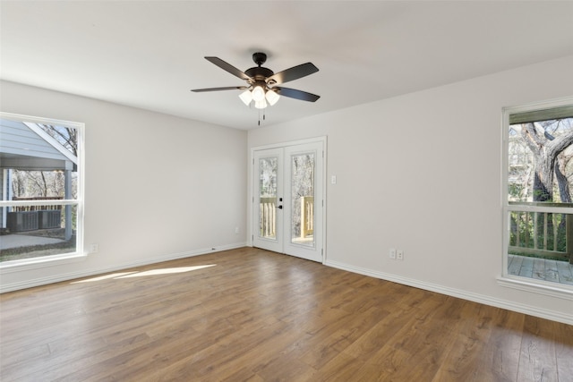 unfurnished room featuring french doors, a ceiling fan, baseboards, and wood finished floors